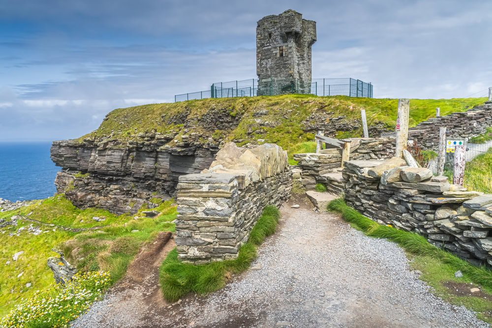 Old Moher Tower on Hags Head, watchtower at the southern end of Cliffs of Moher, popular tourist attraction, Wild Atlantic Way, County Clare, Ireland