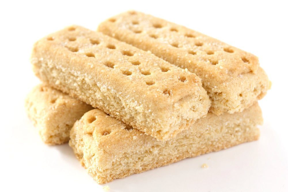 Classic shortbread fingers 4 fingers stacked like logs with the traditional tiny holes in the top and sprinkled with sugar