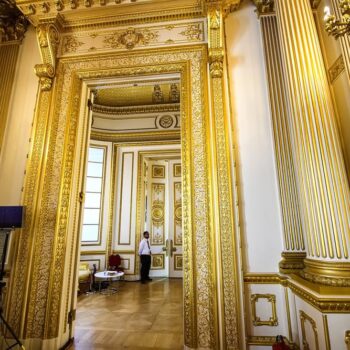 Grand gold entry of Lancaster House with colums and decorative gold elements everywhere. Luxurious interior of Lancaster House in