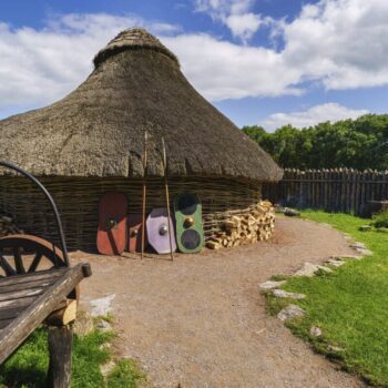 A replica of an ancient hut at the Navan Centre. THe hut is made of intertwined branches and has a thatched rood