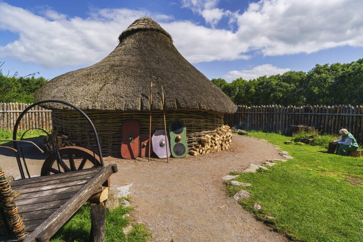 A replica of an ancient hut at the Navan Centre. THe hut is made of intertwined branches and has a thatched rood