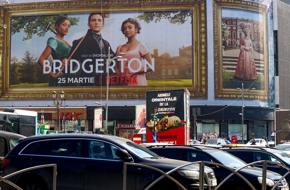 Bucharest, Romania - March 24, 2022: Extra large banner advertising Bridgerton TV Series is displayed on the Unirea Shopping Center, in downtown Bucharest.