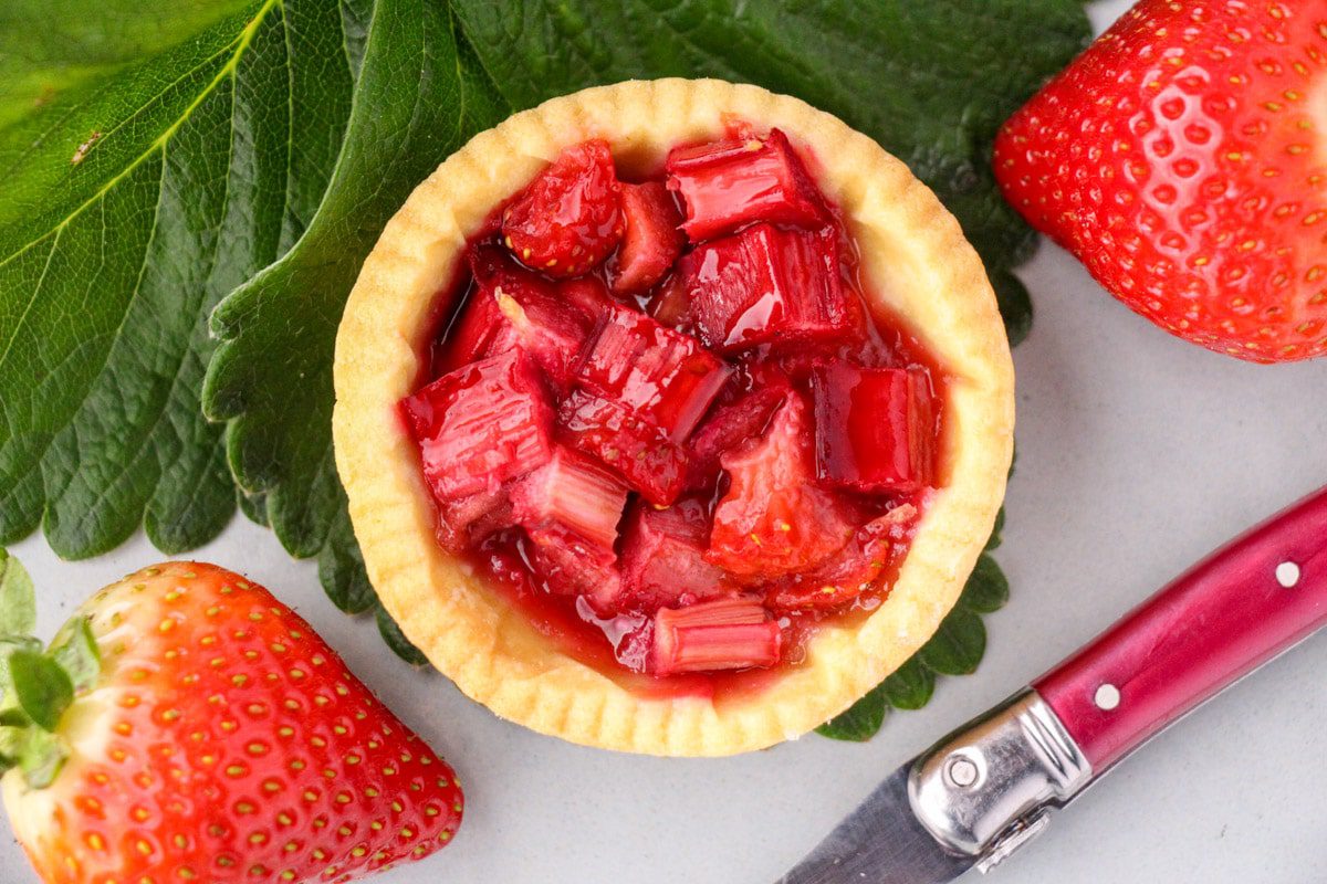 Strawberry rhubarb tarts in a small pastry case