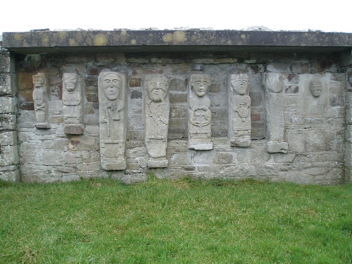 A row of saints carved into a stone wall on White Island
