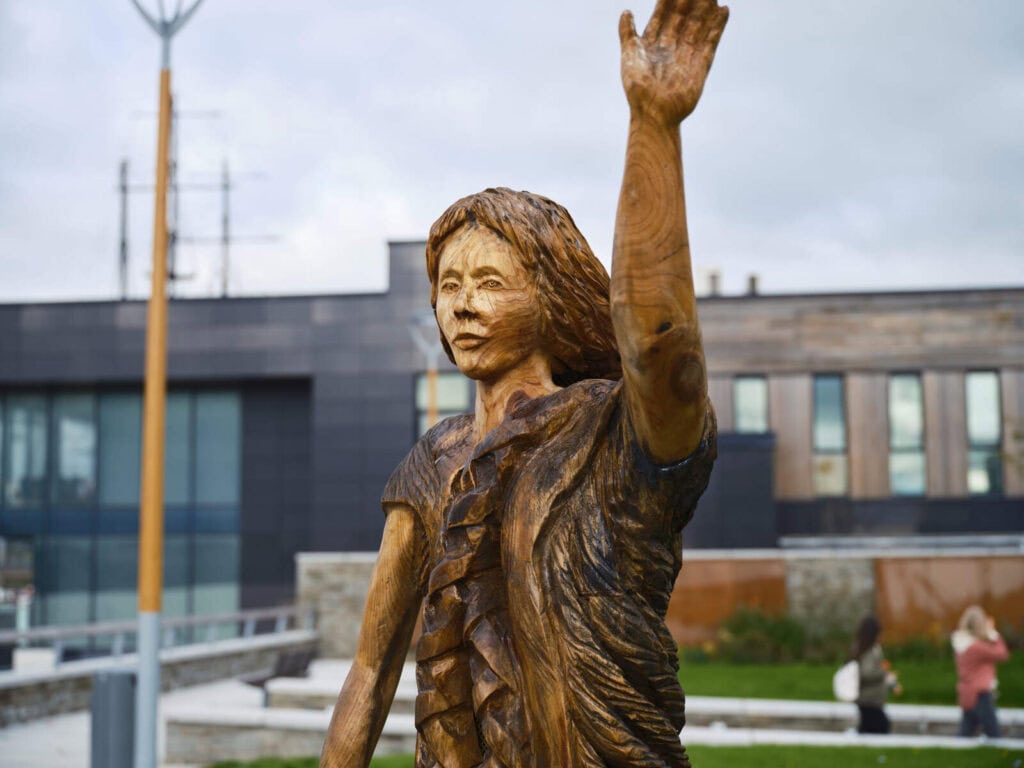 The Dunbrody Famine Ship and IRish emigration experienc in Wexford a statue of an immigrant woman stands just on the pier beside the old ship
