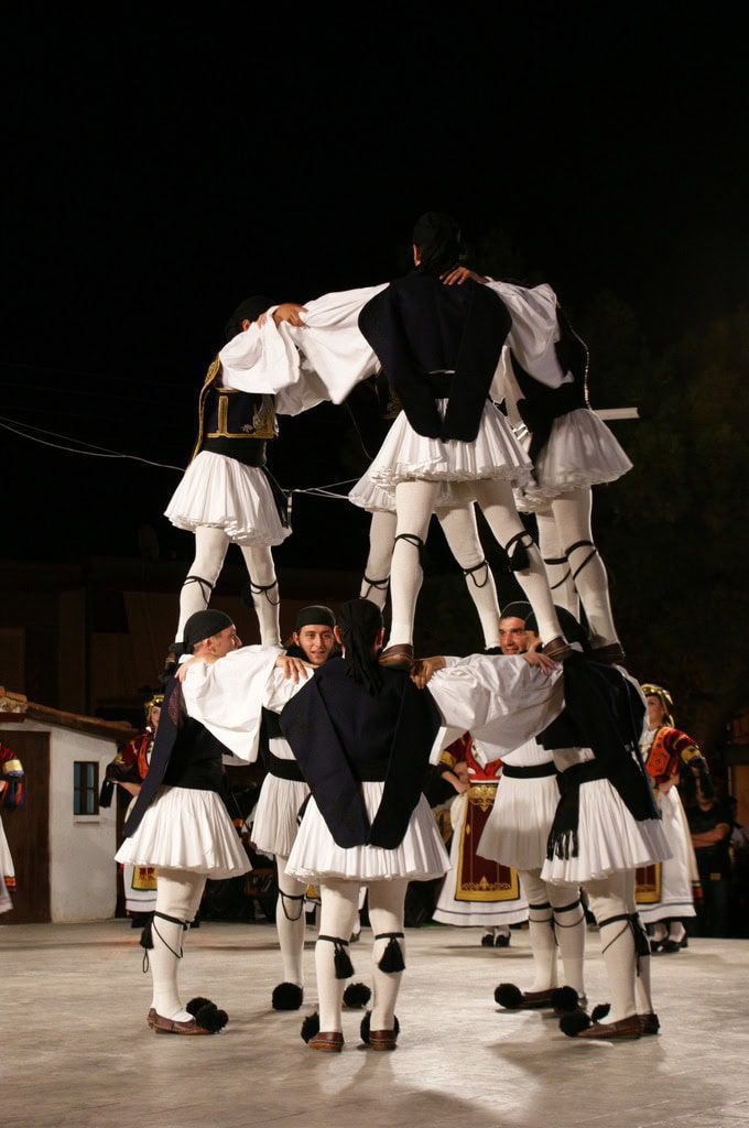 A human pyramid of Greek dancers in national costume