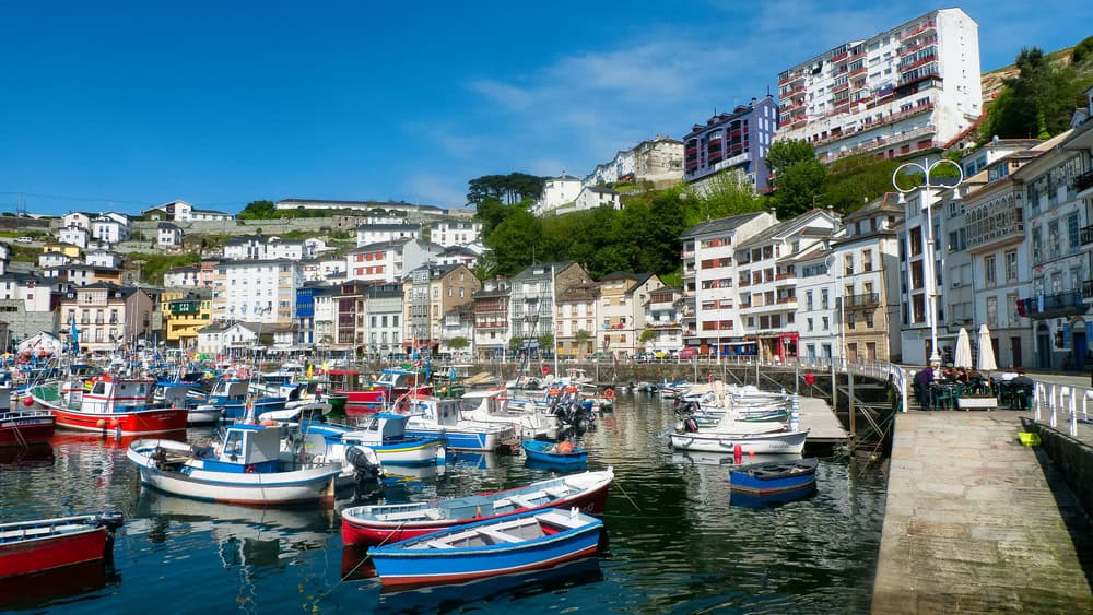 Colorful boats crowd the main fishing port of Luarca, Asturias, Spain