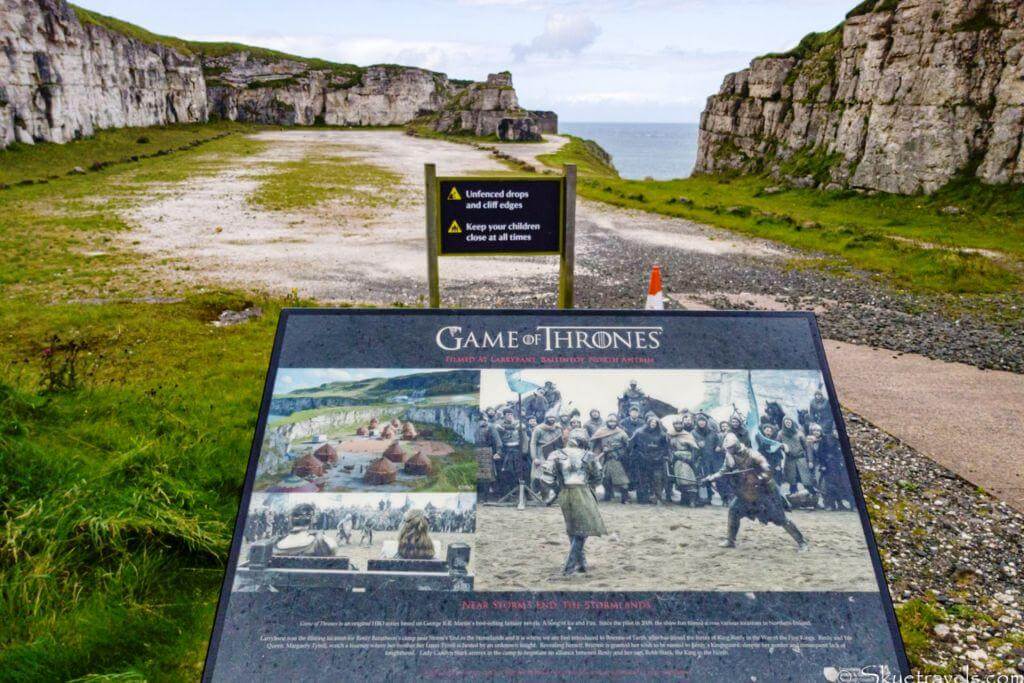 Game of Thrones filming location sign with cliffs and ocean in the background.