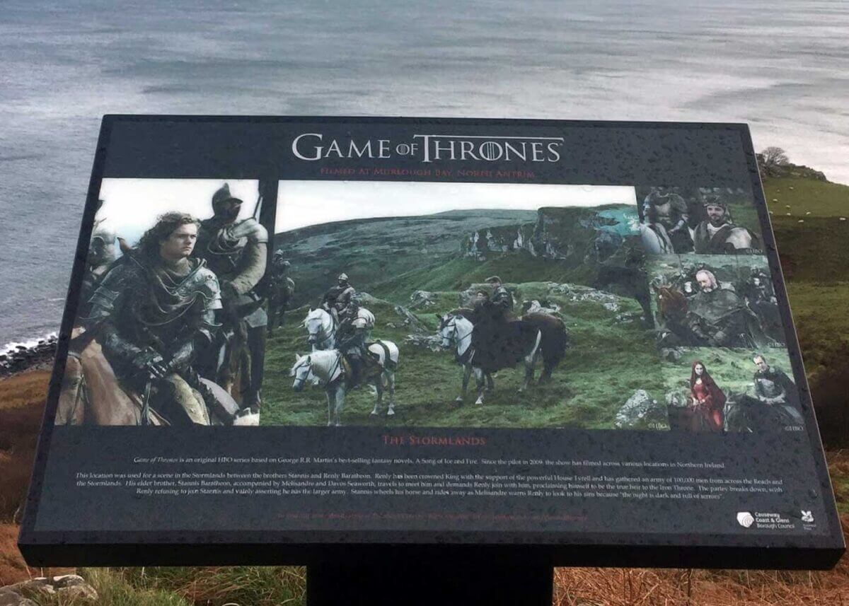 Informational sign about Game of Thrones filming location with images of characters and text.