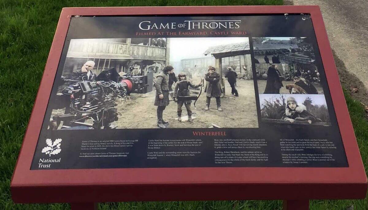 Sign displays Game of Thrones filming at Castle Ward with cast and crew.