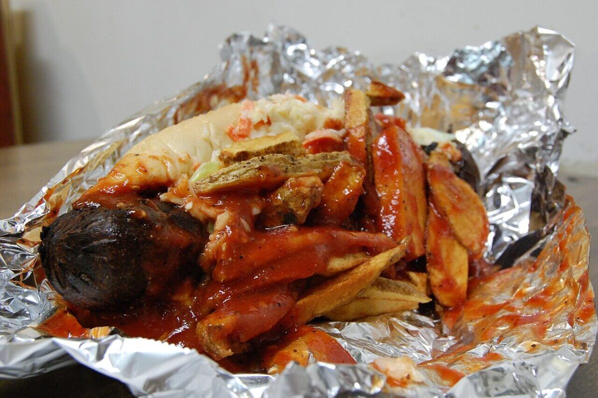 Kielbasa sausage with fries and coleslaw on a hot dog bun