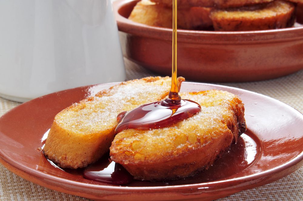Torrijas a Spanish french toast rolled up and served with syrup and custard