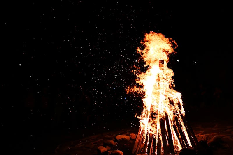 A captivating image of a bonfire burning brightly at night in Bran, Romania.