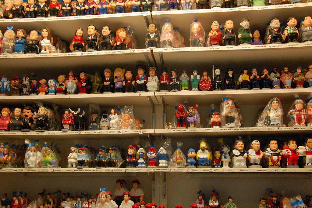 Shelves are filled with rows of small, colorful figurines representing various people and fictional characters.