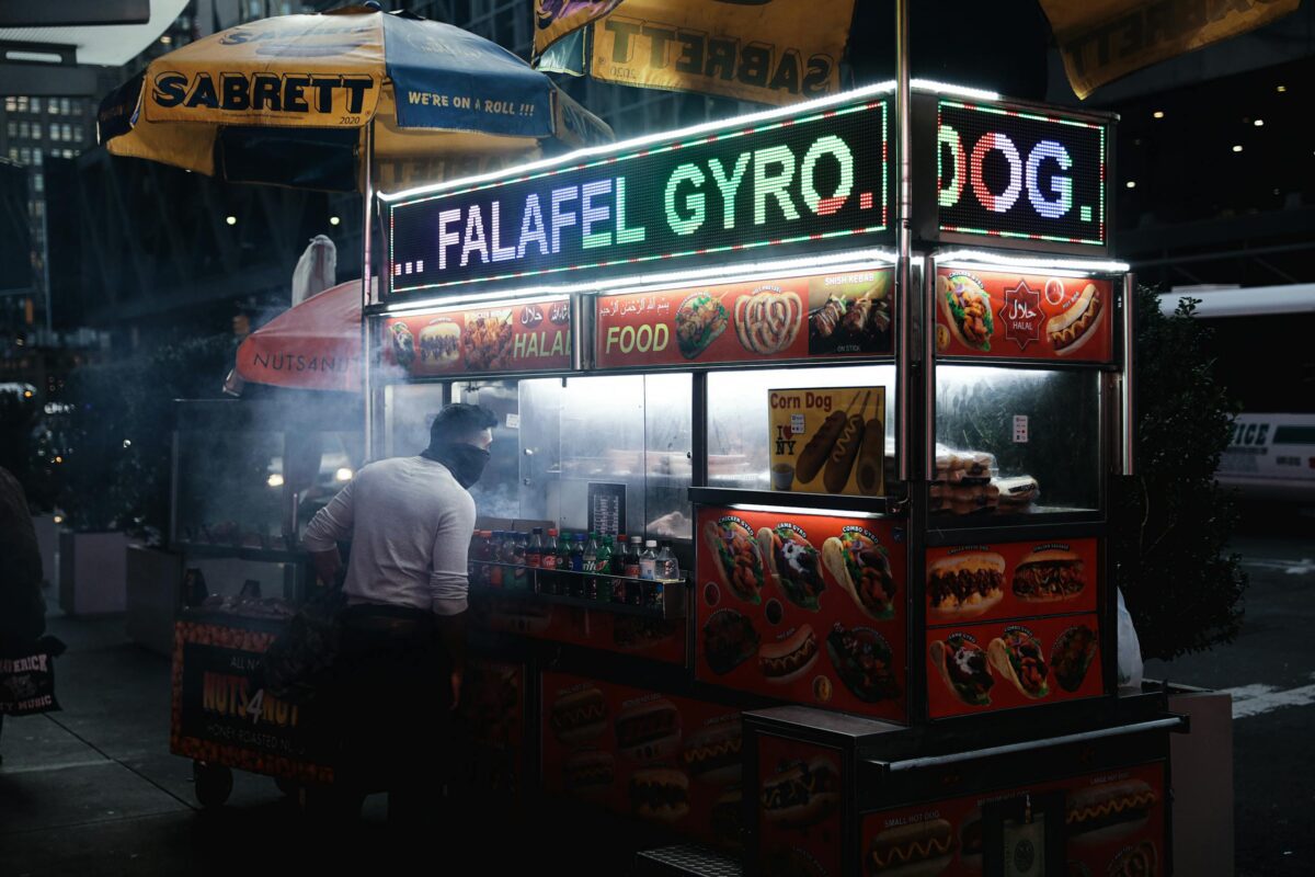 Street food vendor selling falafel and gyros at night in New York City, USA.