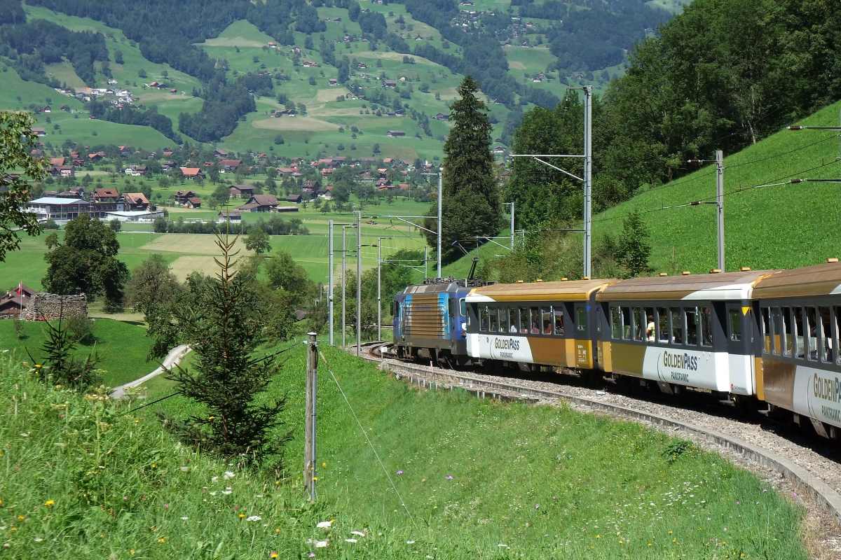 The golden pass train heading through the valleys and mountains