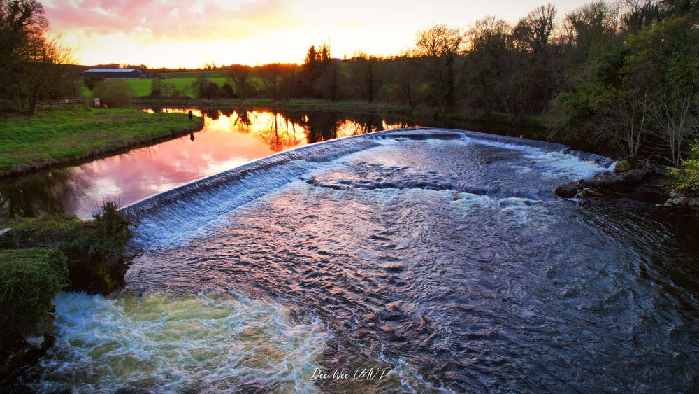 A glowing sunset reflection in the weir on the River Boyne at Ardmulchan, County Meath, Ireland