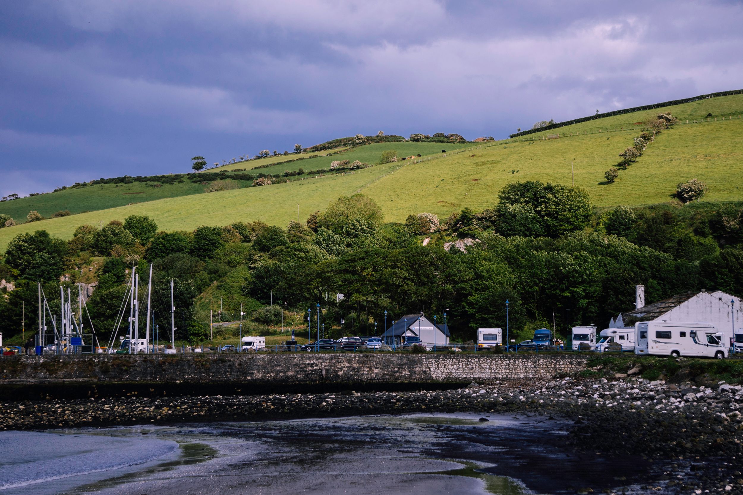 Scenic view of lush hills and marina in Northern Ireland.