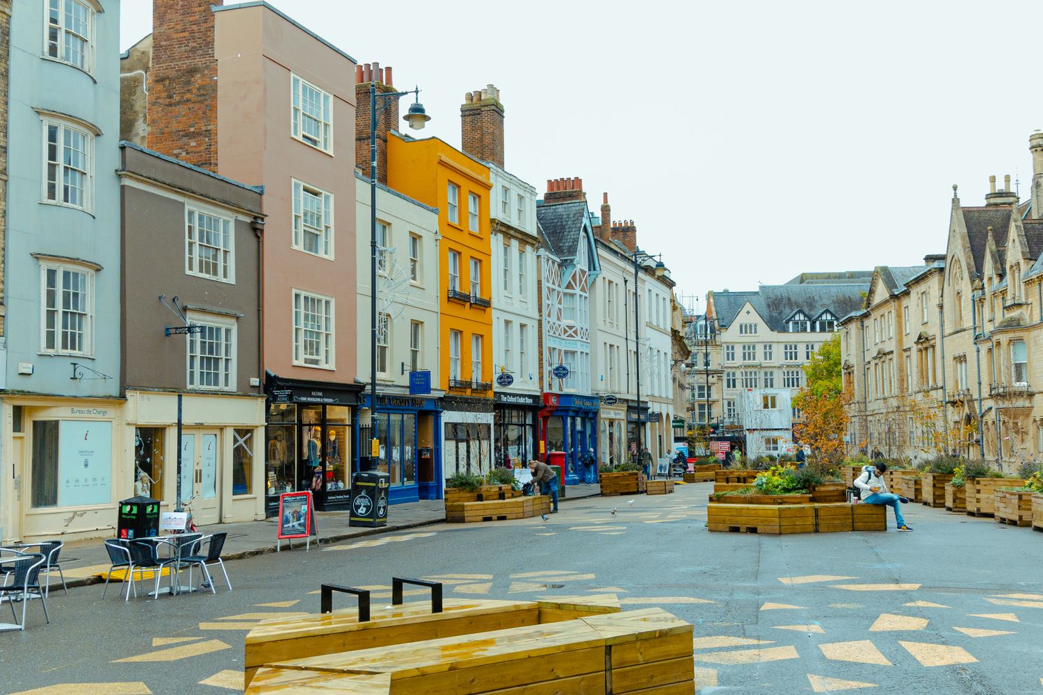 Colorful urban scene in Oxford, England, showcasing charming architecture and street life.