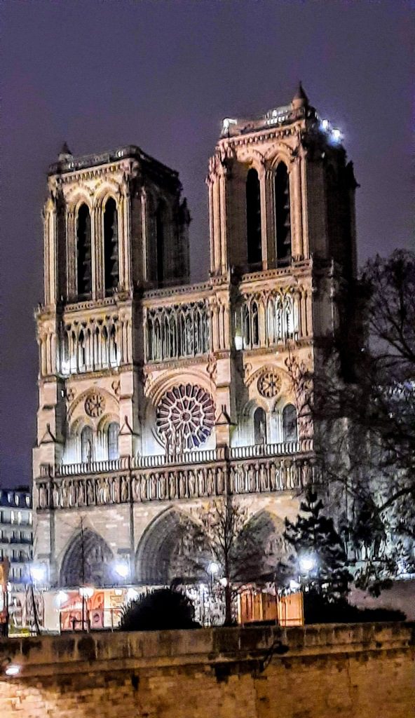 Notre Dame Cathedral illuminated at night in Paris.