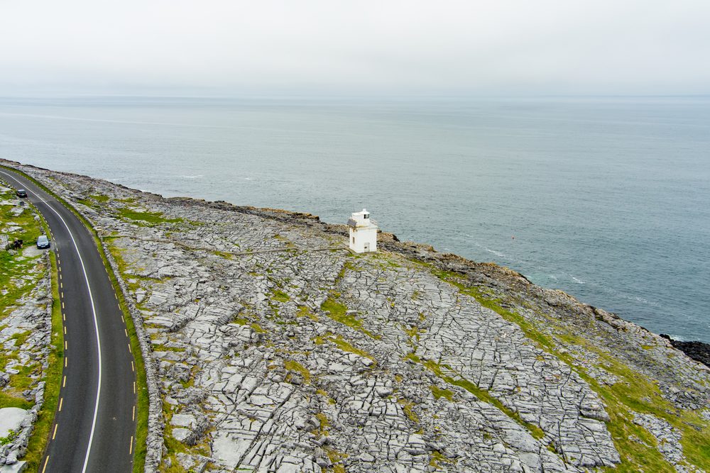 Black Head Lighthouse, situated in the rough rocky landscape of Burren, amidst a bizarre scenery of steep limestone mountains and rocky coastline, County Clare, Ireland.