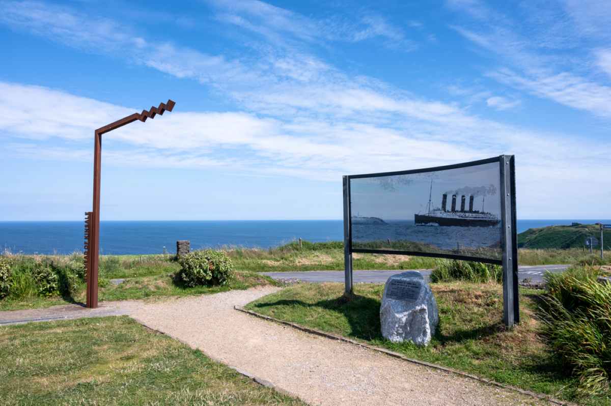 Wild Atlantic Way sign near the edge of the water along with a sign for the Lusitania disaster - things to do in Kinsale