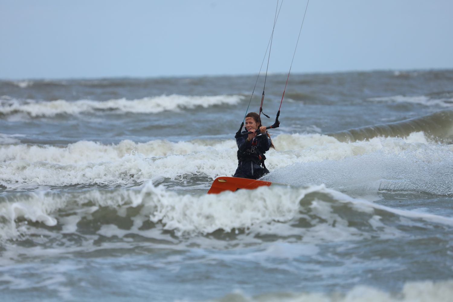 Thrilling kiteboarding experience on ocean waves showcasing action and skill.
