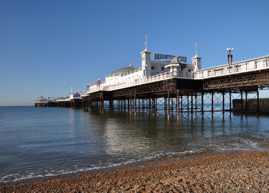 Brighton, United Kingdom - April 16, 2012: Vertical panoramic view of the famous Brighton Pier on a beautiful Spring day. escape from London